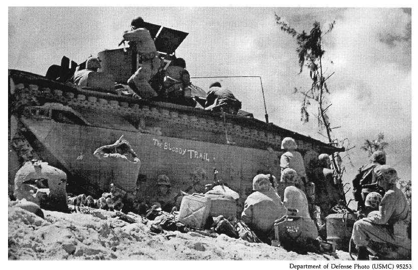 Maines taking shelter behind an LVT on the Peleliu beachead